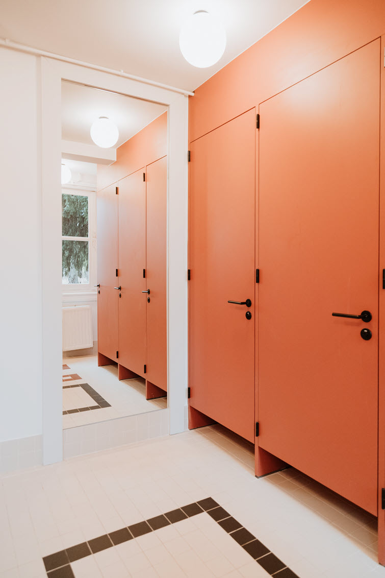 Toilet area with doors and frames finished in Baked Brick finish